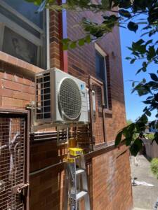 Daikin split system outdoor unit installed on wall brackets