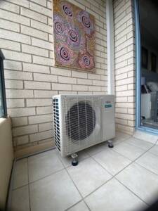 Outdoor AC unit installed on a balcony