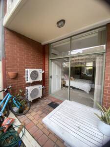Outdoor ac units installed on wall brackets at Bondi
