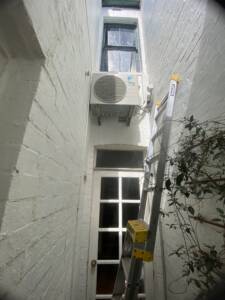 Outdoor AC unit installed on wall brackets at Bronte