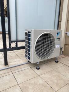 Daikin condenser installed on rubber stands at Bondi