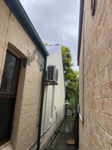 Daikin outdoor unit installed on wall brackets at Coogee